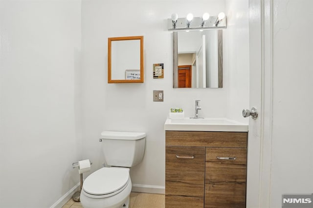 bathroom with toilet and vanity