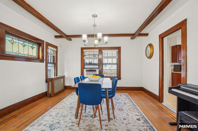 dining room with cooling unit, beam ceiling, light hardwood / wood-style flooring, and a chandelier