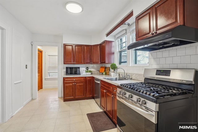 kitchen with appliances with stainless steel finishes, tasteful backsplash, and sink