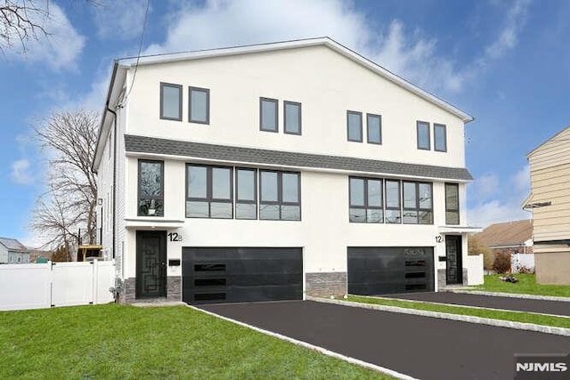 modern home featuring a garage and a front lawn