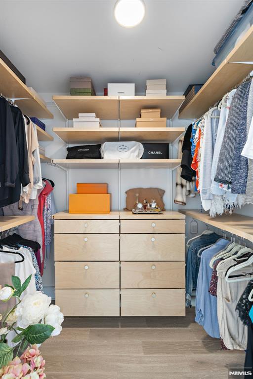 walk in closet featuring light hardwood / wood-style floors