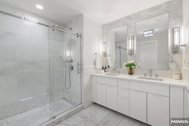 bathroom with vanity and a shower with shower door