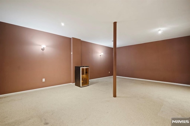 basement featuring light colored carpet