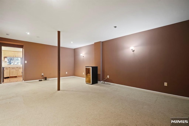 basement featuring light colored carpet