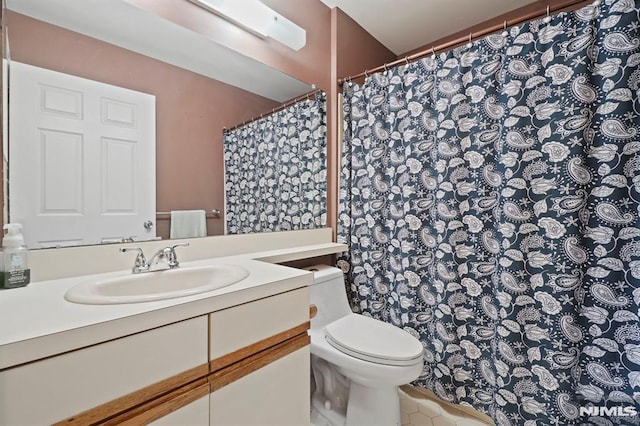 bathroom featuring toilet and vanity