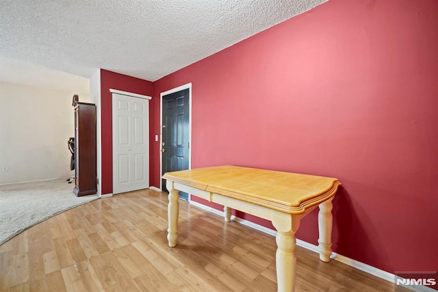 playroom featuring light hardwood / wood-style floors and a textured ceiling