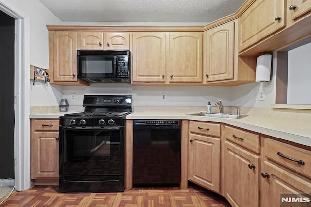 kitchen with a textured ceiling, black appliances, parquet flooring, light brown cabinets, and sink