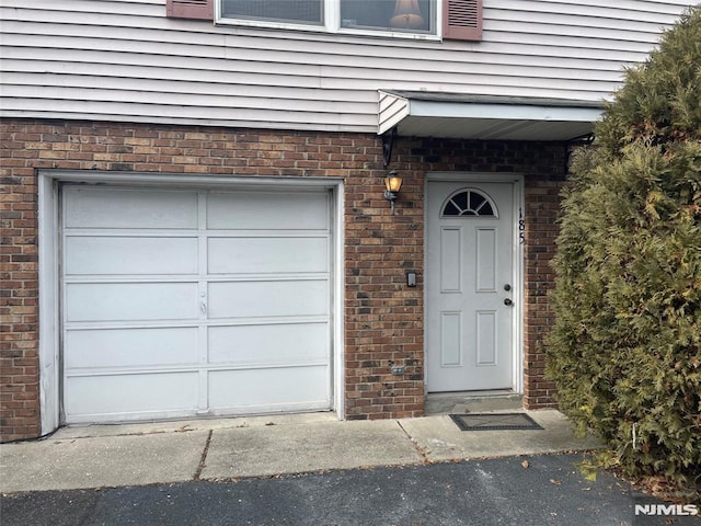 view of exterior entry with a garage