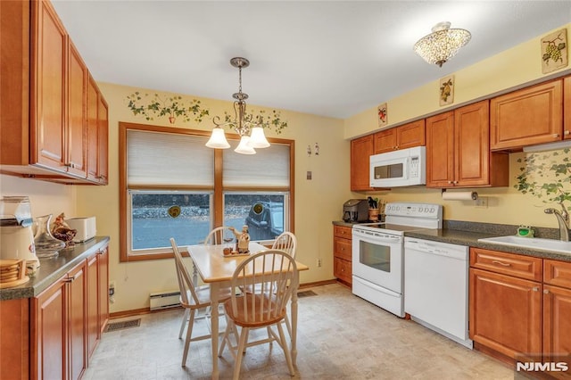 kitchen with pendant lighting, sink, white appliances, and a chandelier