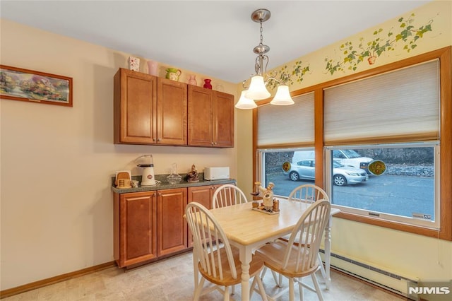 dining area with an inviting chandelier and a baseboard radiator