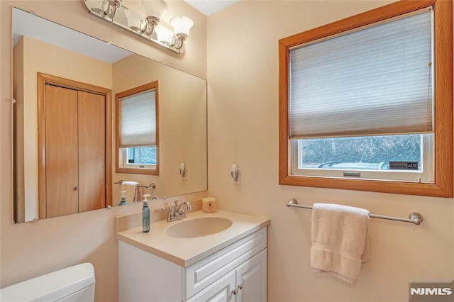 bathroom with toilet and vanity