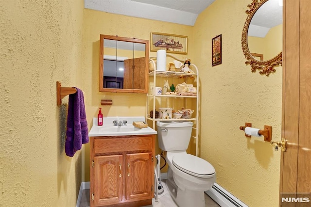 bathroom featuring toilet, a baseboard radiator, and vanity