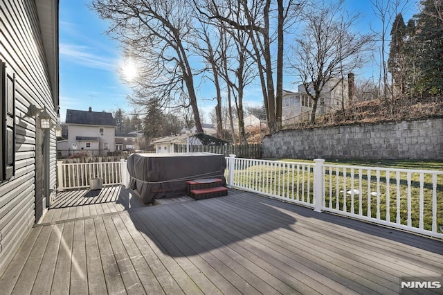 wooden deck with a hot tub