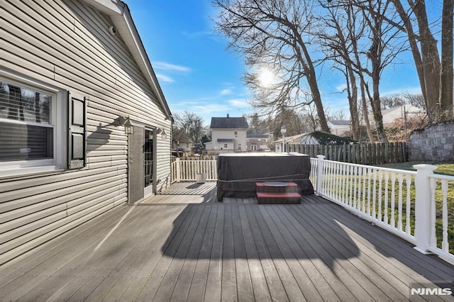 wooden deck featuring a hot tub