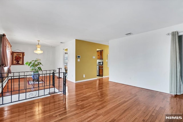 spare room with hardwood / wood-style floors