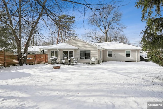 view of snow covered back of property