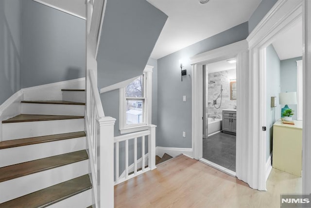 stairs featuring hardwood / wood-style flooring