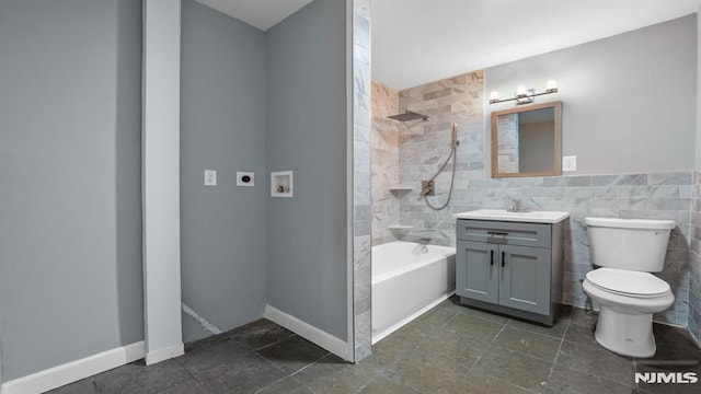 full bathroom with toilet, tiled shower / bath, tile walls, and vanity