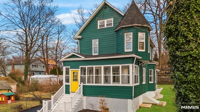 view of front facade featuring a sunroom