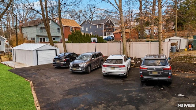 view of parking / parking lot featuring a garage