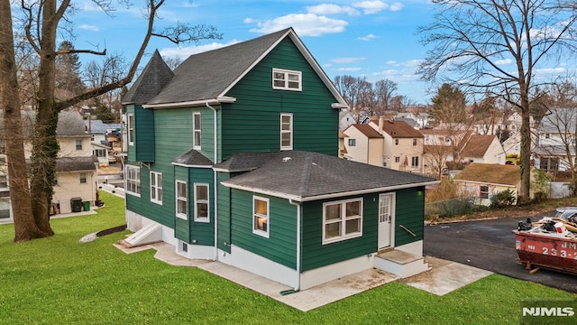 rear view of house with a lawn