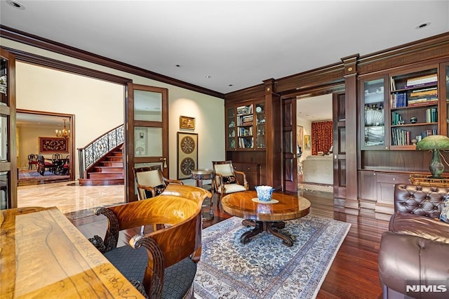 living room featuring dark hardwood / wood-style floors and ornamental molding