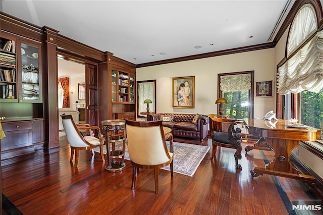 sitting room featuring dark wood-type flooring and ornamental molding