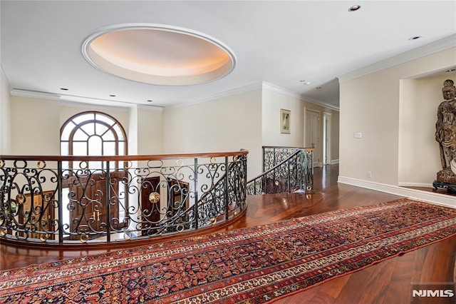 corridor with hardwood / wood-style flooring and crown molding