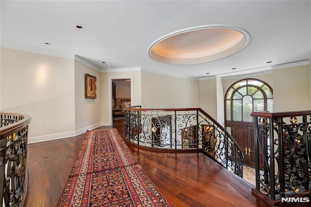 corridor featuring ornamental molding and hardwood / wood-style flooring