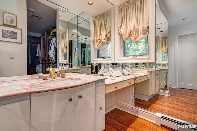 bathroom with vanity, wood-type flooring, and a baseboard radiator