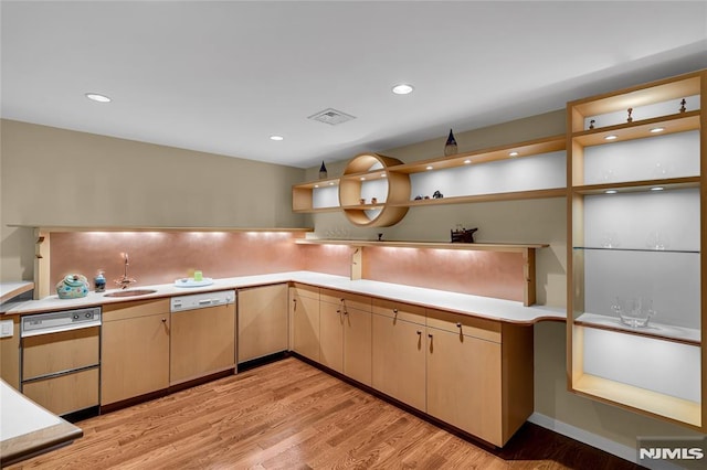 kitchen featuring light brown cabinetry, sink, light hardwood / wood-style floors, and dishwashing machine