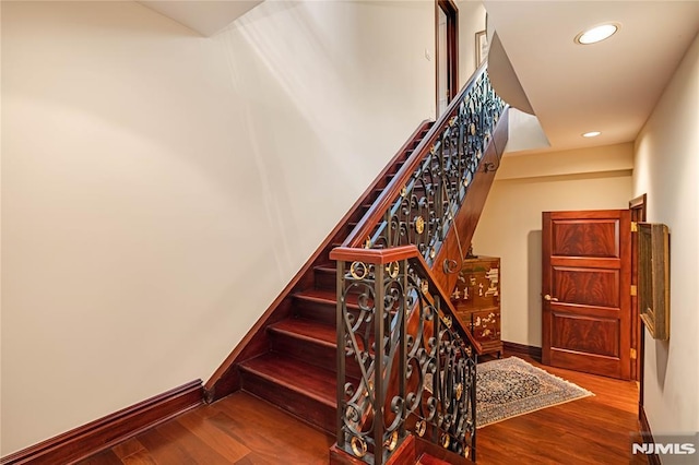 stairs with hardwood / wood-style floors