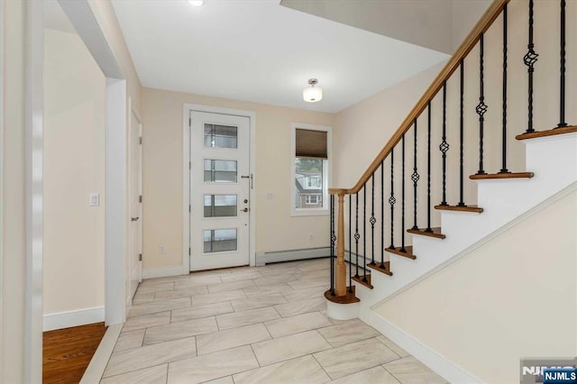 entryway with baseboards, a baseboard radiator, and stairway