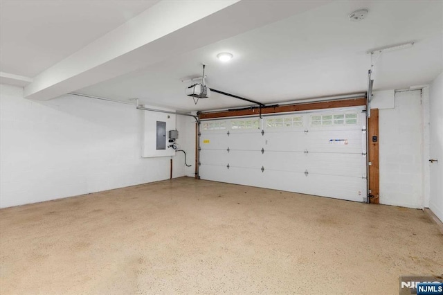 garage with a garage door opener and electric panel