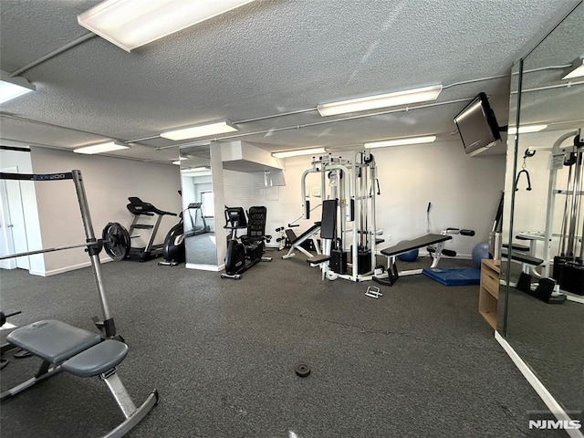 exercise room with a textured ceiling