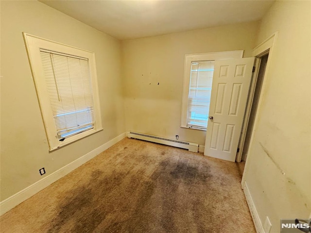 unfurnished room with carpet floors and a baseboard radiator