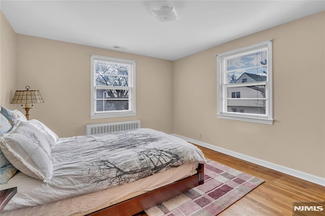 bedroom with wood-type flooring