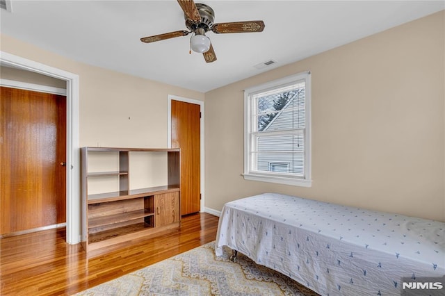 bedroom featuring ceiling fan and hardwood / wood-style flooring