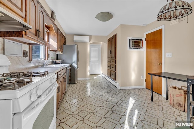 kitchen with sink, backsplash, appliances with stainless steel finishes, and a wall unit AC