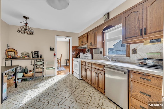 kitchen featuring pendant lighting, dishwasher, sink, backsplash, and white gas range