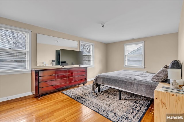 bedroom with hardwood / wood-style flooring