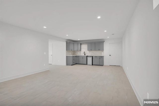 unfurnished living room with sink