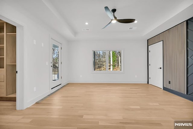 interior space featuring light wood-type flooring, access to outside, and multiple windows