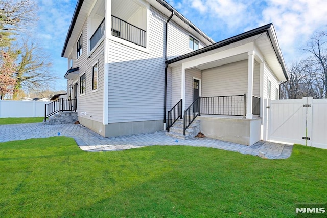 rear view of property featuring a yard