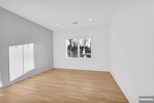 spare room featuring light wood-type flooring