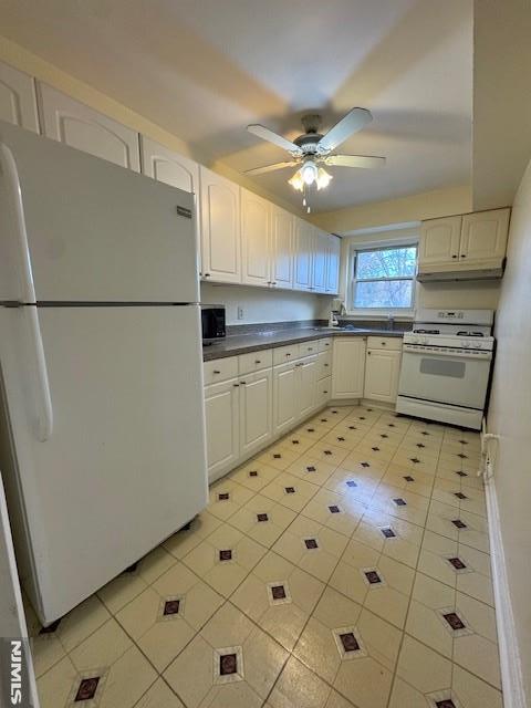 kitchen with ceiling fan, white appliances, and white cabinets