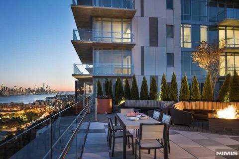 exterior space with a fire pit and a water view