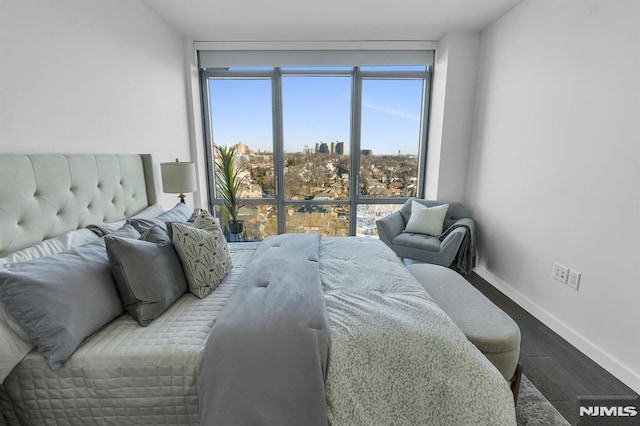 bedroom with hardwood / wood-style flooring and floor to ceiling windows