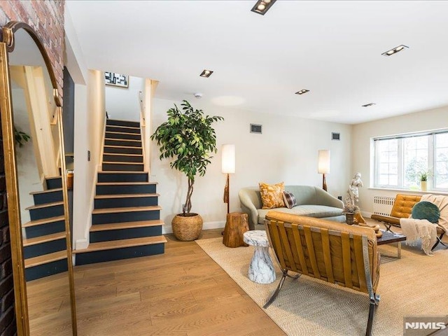 living room featuring radiator and hardwood / wood-style flooring