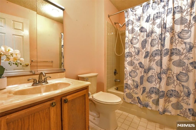 full bathroom featuring toilet, vanity, tile patterned floors, shower / bathtub combination with curtain, and a textured ceiling